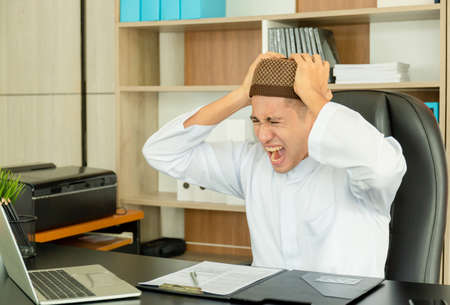Angry modern arabic businessman working in the officeの写真素材