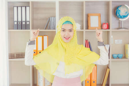 Selective focus of Happiness young business arab middle eastern muslim woman in officeの写真素材