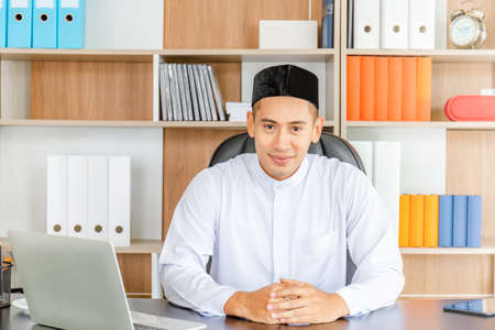 Selective focus of Happy young business arab middle eastern muslim man in officeの写真素材