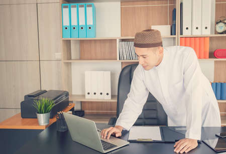 Young business arab middle eastern muslim man in officeの写真素材