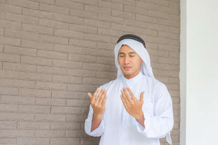 Cheerful young business arab middle eastern muslim man at home with a happy face standing and smilingの写真素材