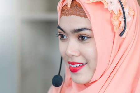 Close up of happiness and smiling beautiful Arab middle eastern businesswoman with headphonesの写真素材
