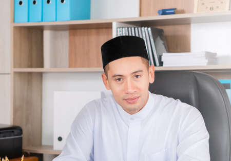 Selective focus of Happy young business arab middle eastern muslim man in officeの写真素材