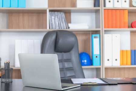 Office workplace with laptop and report papers on wood table for backgroundの写真素材