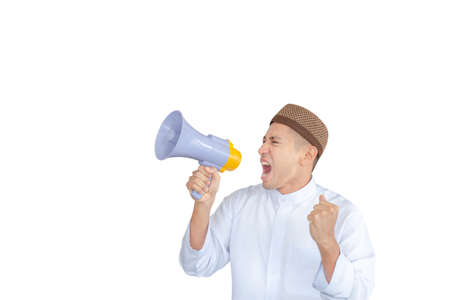 Young business Arab Middle East muslim man with clipping path shouting by megaphone over white backgroundの写真素材
