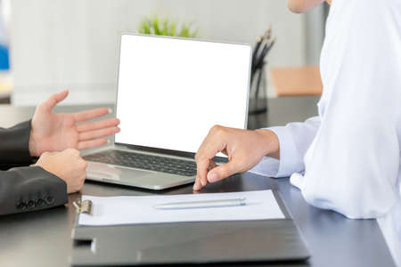Arab middle eastern woman presented the report to the manager. Woman pointing into laptop computer monitorの写真素材