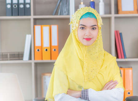 Selective focus of Happiness young business arab middle eastern muslim woman in officeの写真素材