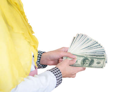 Selective focus of young business muslim woman holding and showing money banknotes with clipping...