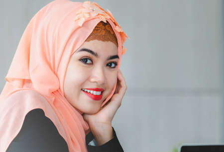 Selective focus of Happiness young arab middle eastern muslim business woman smiling in officeの写真素材