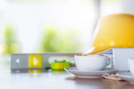 Selective focus of Coffee in white cup on wooden table with blurred backgroundの写真素材