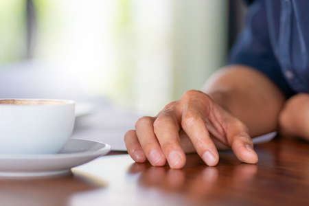 Selective focus of Casual young business engineer man hand with coffee cup and blurred backgroundの写真素材