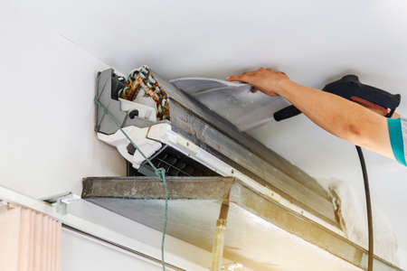 Repairman clean mold dirty inside compartments air conditioner in system air conditioning system, maintenance concept.の写真素材