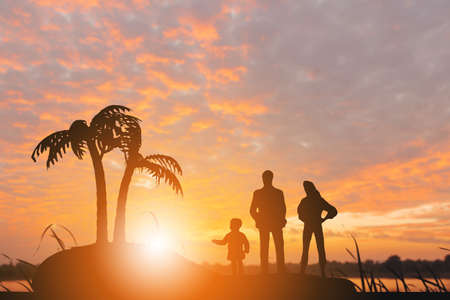 Silhouette of Father mother and daughter playing on stone at beach evening sunset background, Happy...
