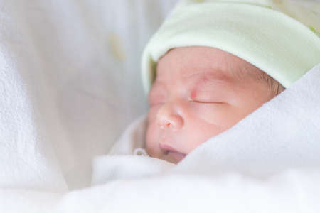 Selective focus of asian newborn baby boy sleeping at hospitalの写真素材