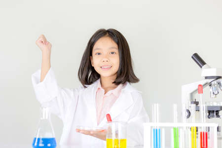 Children science concept, Happy little girl playing doing chemical experiments at the laboratoryの写真素材