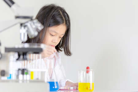 Children science concept, Happy little girl playing doing chemical experiments at the laboratoryの写真素材