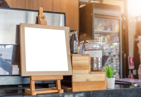 Blank wood frame stand mockup poster display in coffee shopの写真素材