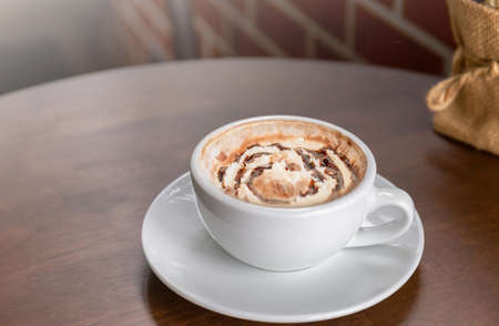 Hot chocolate in a white cup on tableの写真素材