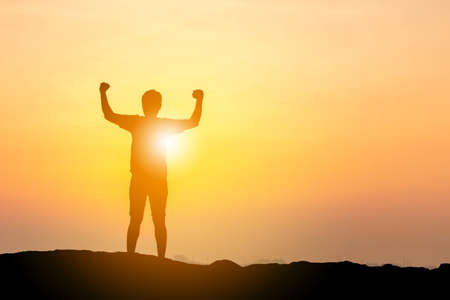 Silhouette of Man with clipping path celebration success happiness on a mountain top at beach evening sky sunset / sunrise background, Sport and active life conceptの写真素材