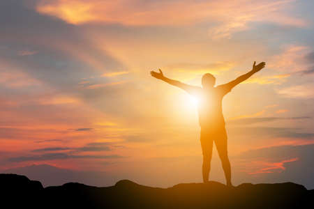 Silhouette of Man Celebration Success Happiness on a mountain top Evening Sky Sunset / sunrise Background, Sport and active life Concept with clipping pathの写真素材