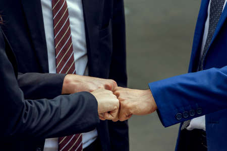 Success Teamwork Concept, Business people team joining hands outside office city backgroundの写真素材
