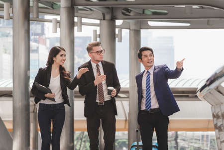 Business man and businesswomen over blurred city background, Success and Happiness Team Conceptの写真素材