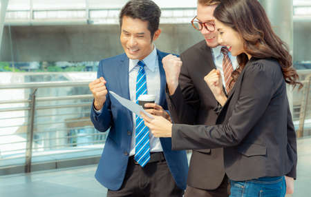 Business man and businesswomen over blurred city background, Success and Happiness Team Conceptの写真素材