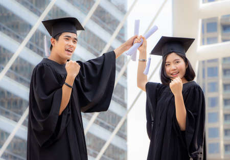 Close up of graduate student holding a diploma, Education concept.の写真素材