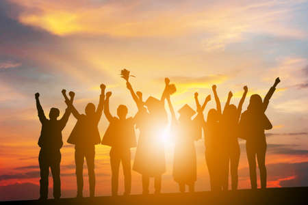Silhouette of Business People Celebration Success Happiness Team at Sunset Evening Sky Background, with clipping path.の写真素材