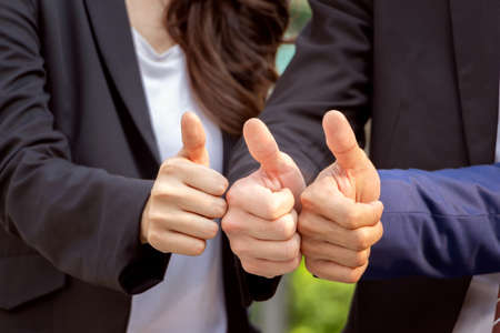 Close up of Team giving thumb up as sign of Success, Business Teamwork Conceptの写真素材