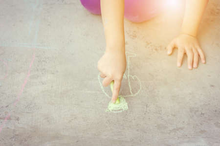 Close up of Kid hand drawing a cartoon on the floorの写真素材