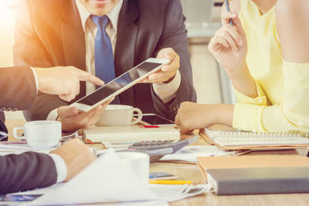 Group of Business Team Meeting Strategy Marketing in a coffee shop chatting to each other while...