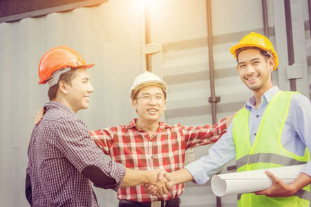 Success and happiness teamwork concept, engineer businessman team handshake finishing up a meeting business partnership after good jobの写真素材