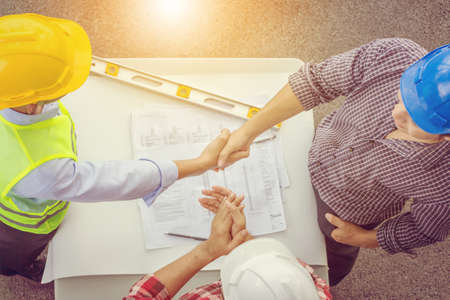 Success and happiness teamwork concept, engineer businessman team handshake finishing up a meeting business partnership after good jobの写真素材