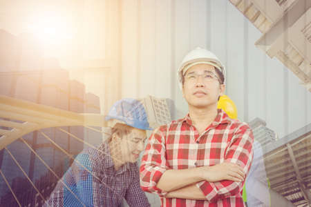 Teamwork think big concept, Double exposure of business engineer team thinking and looking forward with blured city background.の写真素材