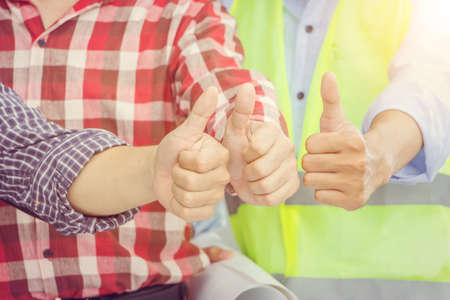 Business engineer man team giving thumb up as sign of Success Business Teamwork Concept.の写真素材