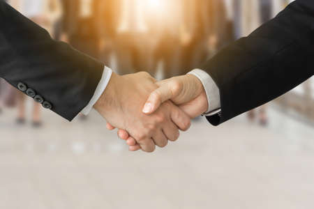 Success and Happiness Team Concept, Business man handshake over blurred business people group background with clipping pathの写真素材
