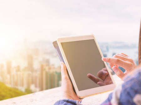 Close up of casual women hand holds mobile smartphone in cafe, selective focusand blurry background.の写真素材