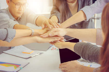 Success Business people Teamwork Concept, Businessman and business woman joining hands at meeting roomの写真素材