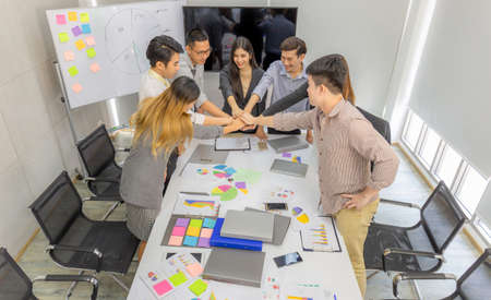 Success Business people Teamwork Concept, Businessman and business woman joining hands at meeting roomの写真素材