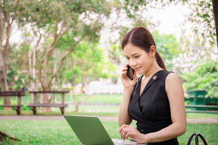 Close up of Business women working with laptop at the park.の写真素材