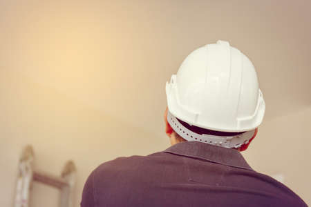 Close up of Technician man white safety helmet with clipping path looking ceiling