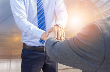 Success and Happiness concept, Business man handshake at city outside office sunset double exposure.の写真素材