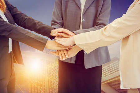 Success Teamwork Concept, Business people joining hands city background.の写真素材