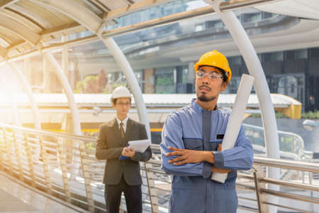 Construction and Maintenance Think Big concept, Business engineer planing and male architect in helmet with city background.の写真素材