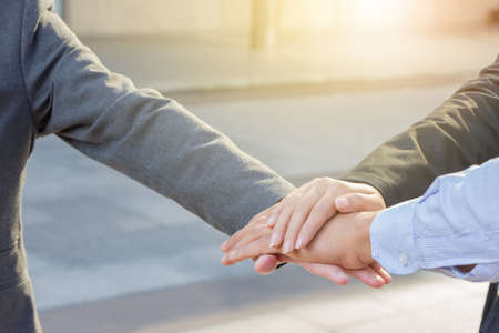 Success Teamwork Concept, Business people joining hands city background.の写真素材