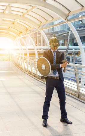 Fighting Business Warrior Concept, Businessman Knight Sword and Shield in City Background.の写真素材