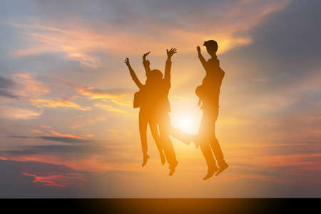 Silhouette of Business People Celebration Success Happiness Team at Sunset Evening Sky Backgroundの写真素材