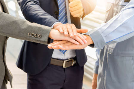 Success Teamwork Concept, Business people joining hands city background.の写真素材