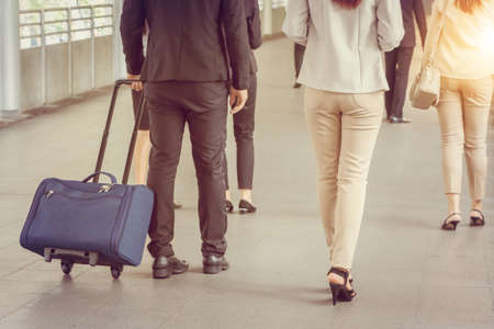 Businessman and businesswoman traveler with luggage at city background, Business People Commuter Walking City Life Concept.の写真素材